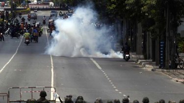 Thai soldiers shoot tear gas at anti-government protesters to secure an area near Lumpini Park in downtown Bangkok.