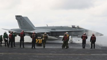 An F/A-18 fighter prepares to take off from the deck of the aircraft carrier USS Carl Vinson at an unidentified location in the international waters, east of the Korean Peninsula.