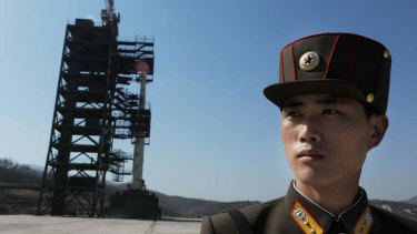 Missile controversy... a North Korean soldier stands guard in front of an Unha-3 rocket at Tangachai -ri space centre in April.