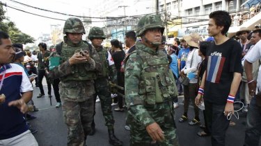 Civil unrest: Thai military medics head to the scene of an explosion at an anti-government protest camp at the Victory monument in central Bangkok.