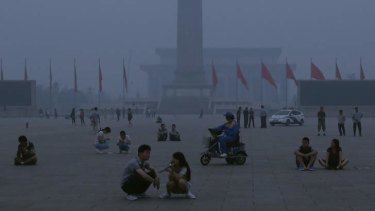 Smoke alarm: Tourists in Beijing's Tiannanmen Square on a high-pollution day.