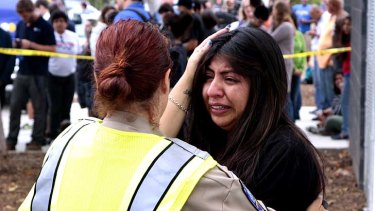 A women is comforted by a traffic officer near Santa Monica College.