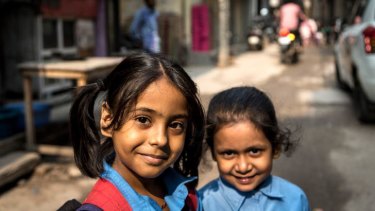 Farhana Khan walks her five-year-old neighbour Aaliya home from school to the tiny one room family home in Govindpuri she shares with her parents and sister Farhana.