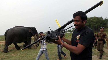 A WWF official carries a drone at the Kaziranga National Park.