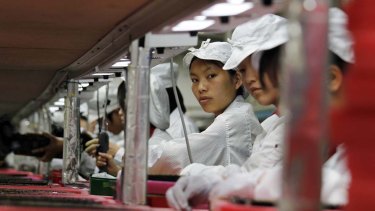 Workers toil at one of Foxconn's factories in China.