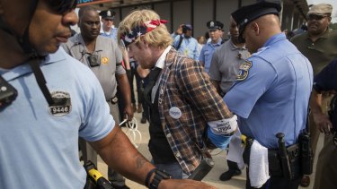 A protester is arrested on the first day of the Democratic National Convention.