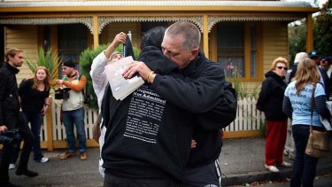 Kevin Russell hugs a fellow marcher as Jewish and Aboriginal supporters re-enact the 1938 protest march of his great-grandfather, Aboriginal activist William Cooper.