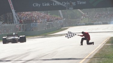 The flag goes down at the finishing line as Damon Hill wins the first Australian Grand Prix held at Melbourne in the modern era.
