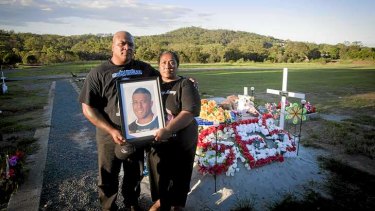 Tragic: The parents of Mosese Fotuaika, Peni and Lisa, at the Brisbane graveyard where their son was buried.