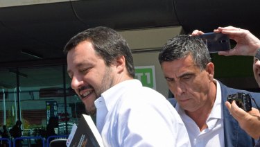 The League leader Matteo Salvini gets in a car as he arrives at Fiumicino airport near Rome.