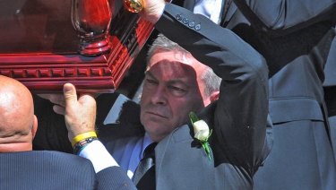 Borce Ristevski carries his wife's coffin.