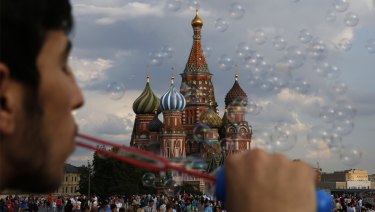 A young man blows bubbles in Red Square during the 2018 soccer World Cup in Moscow.