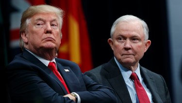 President Donald Trump sits with Attorney General Jeff Sessions during the FBI National Academy graduation ceremony in Quantico, Virginia in December. 