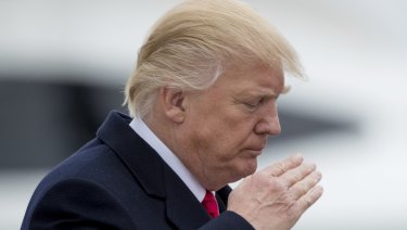 US President Donald Trump saluting.