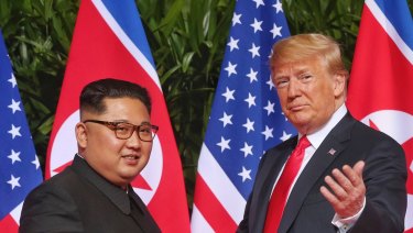 US President Donald Trump gestures toward the media with North Korea leader Kim Jong-un.