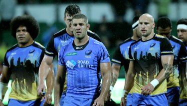 Dark days: Matt Hodgson, centre, and team mates after the Western Force's last Super Rugby game.