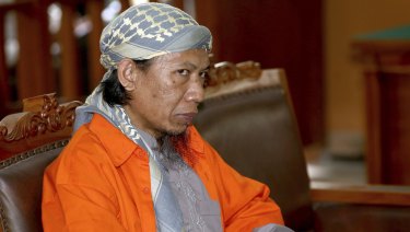 Indonesian militant Oman Rohman, popularly known as Aman Abdurrahman, sits on the defendant's chair during his trial.