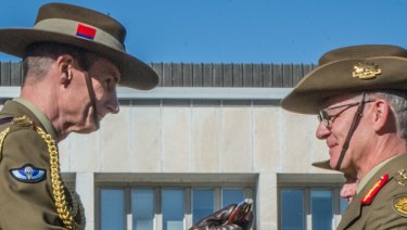 Lieutenant General Angus Campbell hands over command of the Australian Army to Lieutenant General Rick Burr during a ceremony in Canberra.