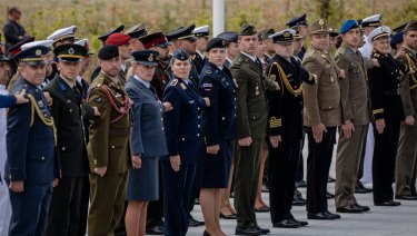 Military personnel from member states stand to attention during the NATO summit at the military and political alliance's headquarters in Brussels, Belgium.