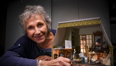 Small world: miniature artist Lyn Mallett with her artist studio crammed with curious, tiny objects that she made for the Mirabel Foundation.  