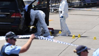 Forensic officers scour Mick Hawi's SUV for clues following the shooting at Rockdale.
