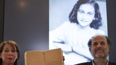 Teresien da Silva, left, and Ronald Leopold of the Anne Frank Foundation show a facsimile of Anne Frank's diary with two pages taped off during a press conference at the foundation's office in Amsterdam, Netherlands.