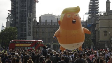 A six-meter high baby blimp of Donald Trump is flown as a protest against his visit, in Parliament Square backdropped by the scaffolded Houses of Parliament and Big Ben in London on Friday.