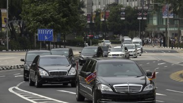 The North Korean motorcade, believed to be carrying North Korean leader Kim Jong-un, travels along Singapore's Orchard Road on Sunday, ahead of the summit with US leader Donald Trump..