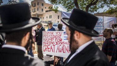 Ultra orthodox Jews stand by supporters of Donald Trump outside the new American embassy in Jerusalem on Monday.
