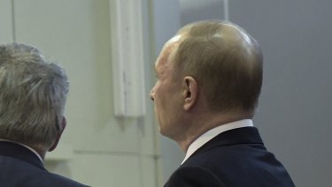 Russian President Vladimir Putin, right, listens to President of National Research Centre which oversees Russian nuclear technology developments.