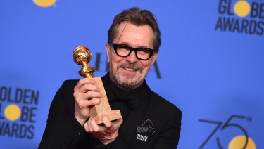 Gary Oldman poses in the press room with the award for best performance by an actor in a motion picture - drama for Darkest Hour.