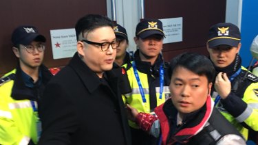 Howard is led away by police officers at the 2018 Winter Olympics in Pyeongchang.