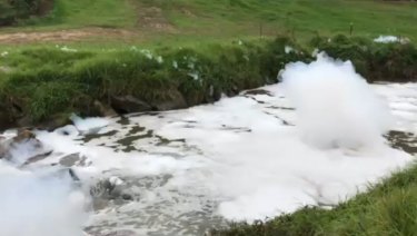 Foam fills a creek in Dandenong on Sunday. 