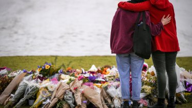 Mourners at the make shift memorial where Eurydice Dixon's body was found at the Princes Park, North Carlton.