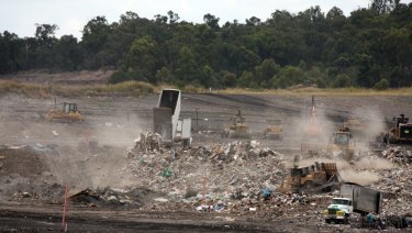 Queensland waste trucks dump unprocessed construction waste from NSW at Cleanaway's New Chum landfill in Ipswich after it has passed through Cleanaway's recycling facility at Willawong in January.