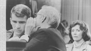 Then- Lieutenant Colonel Oliver North and his attorney, Brendan Sullivan, hold a whispered conversation during hearings before the congressional Iran-Contra Committee on Capitol Hill in July 1987. North's wife, Betsy, looks on. 