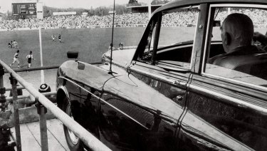 Robert Menzies watches the footy from his Bentley, parked on a specially built ramp in Melbourne, 1972. 