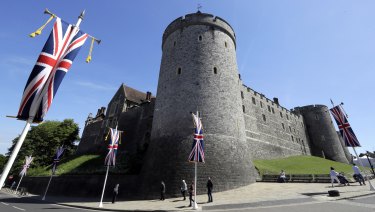 Flags fly in front of Windsor Castle's walls