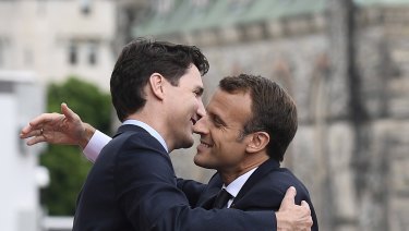 Justin Trudeau and Emmanuel Macron embrace in Ottawa ahead of the G7 summit.