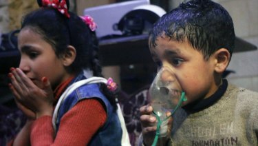 This image released early Sunday, April 8, 2018 by the Syrian Civil Defense White Helmets, shows a child receiving oxygen through respirators following an alleged poison gas attack in the rebel-held town of Douma, near Damascus.