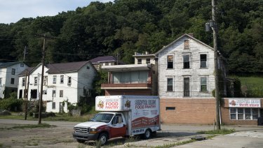 A food pantry truck in a parking lot in front of abandoned homes and businesses in Ohio, one of the key states in Donald Trump's victory.