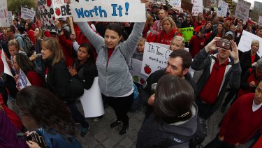 Teachers and their supporters from Douglas and Jefferson counties in Colorado cheer during a teacher rally.
