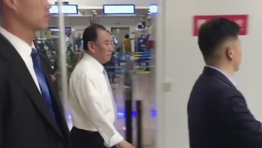 Kim Yong Chol, centre, a former military intelligence chief who is now Kim Jong Un's top official on inter-Korean relations, walks through Beijing airport after his arrival. 