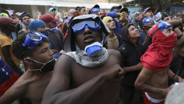 Venezuelan migrants under the Simon Bolivar International Bridge plead for people to support them with food and water.