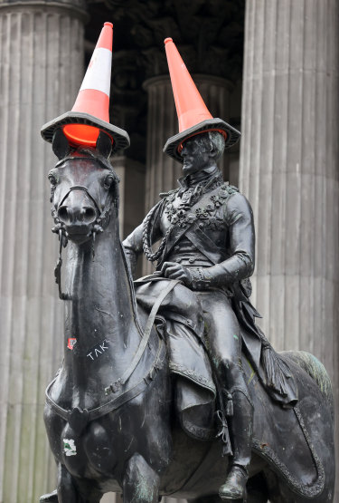 The Duke of Wellington statue with cones placed on top of it outside the Gallery Of Modern Art in Glasgow, Scotland. 