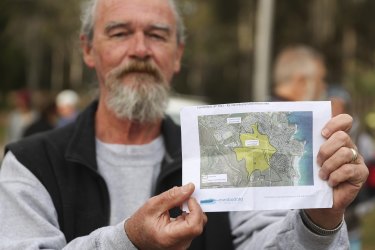 Councillor and local resident Pat McGinlay holds up an image of the proposed site of development in Dalmeny.