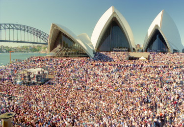 Fans wait for Crowded House to perform on the forecourt of the Sydney Opera House on November 24, 1996.