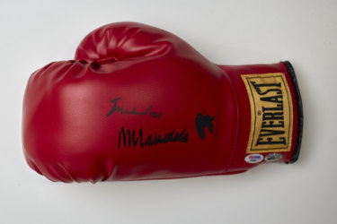 Red leather boxing glove signed by Muhammad Ali for Nelson Mandela. 