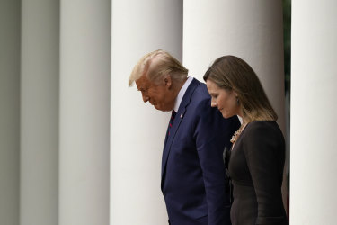 President Donald Trump walks with Judge Amy Coney Barrett to a news conference to announce Barrett as his nominee to the Supreme Court.
