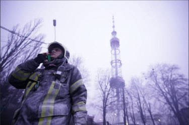 An emergency services worker responds to a Russian attack on the Kyiv television tower on Tuesday, March 1, 2022.